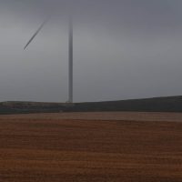 A wind turbine hiding in the mist