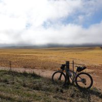 Look at my bike leaning on a fence